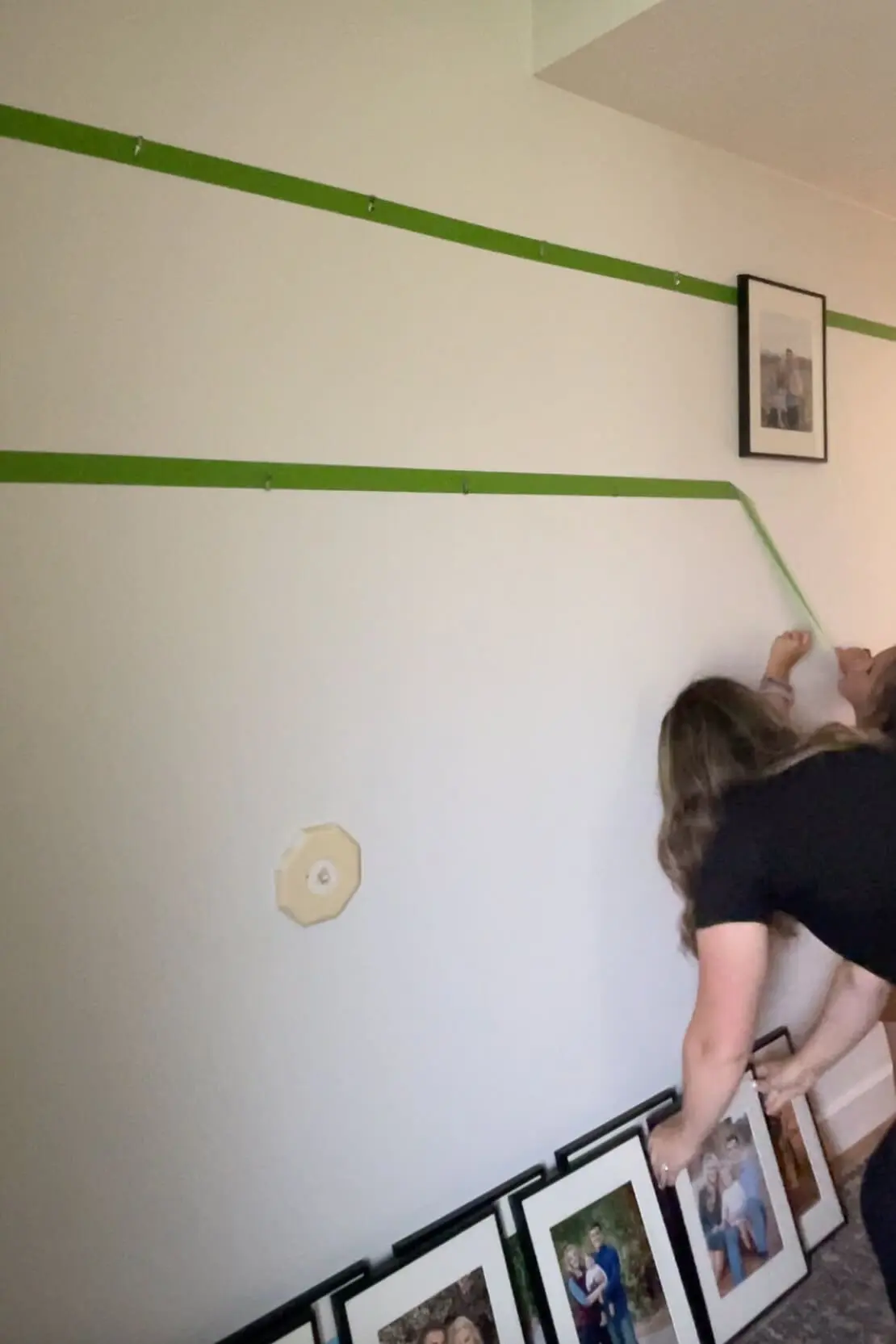 Taking tape off of wall when using it as a guide for hanging a gallery wall evenly.